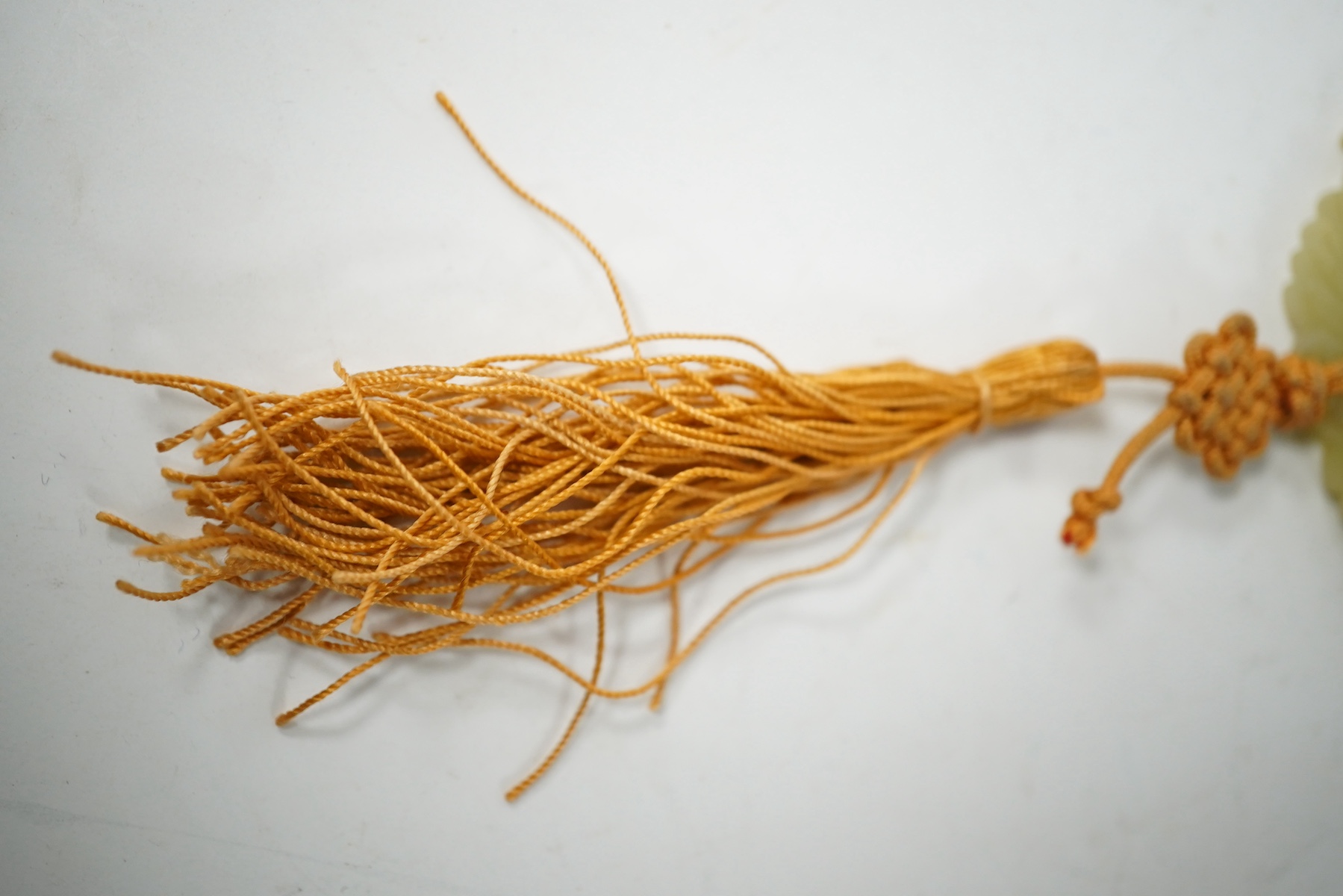 A Chinese pale celadon jade 'basket of flowers' pendant plaque, 19th century, 6cm wide. Condition - good